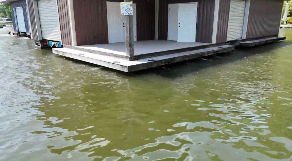 A house is floating on top of a body of water.