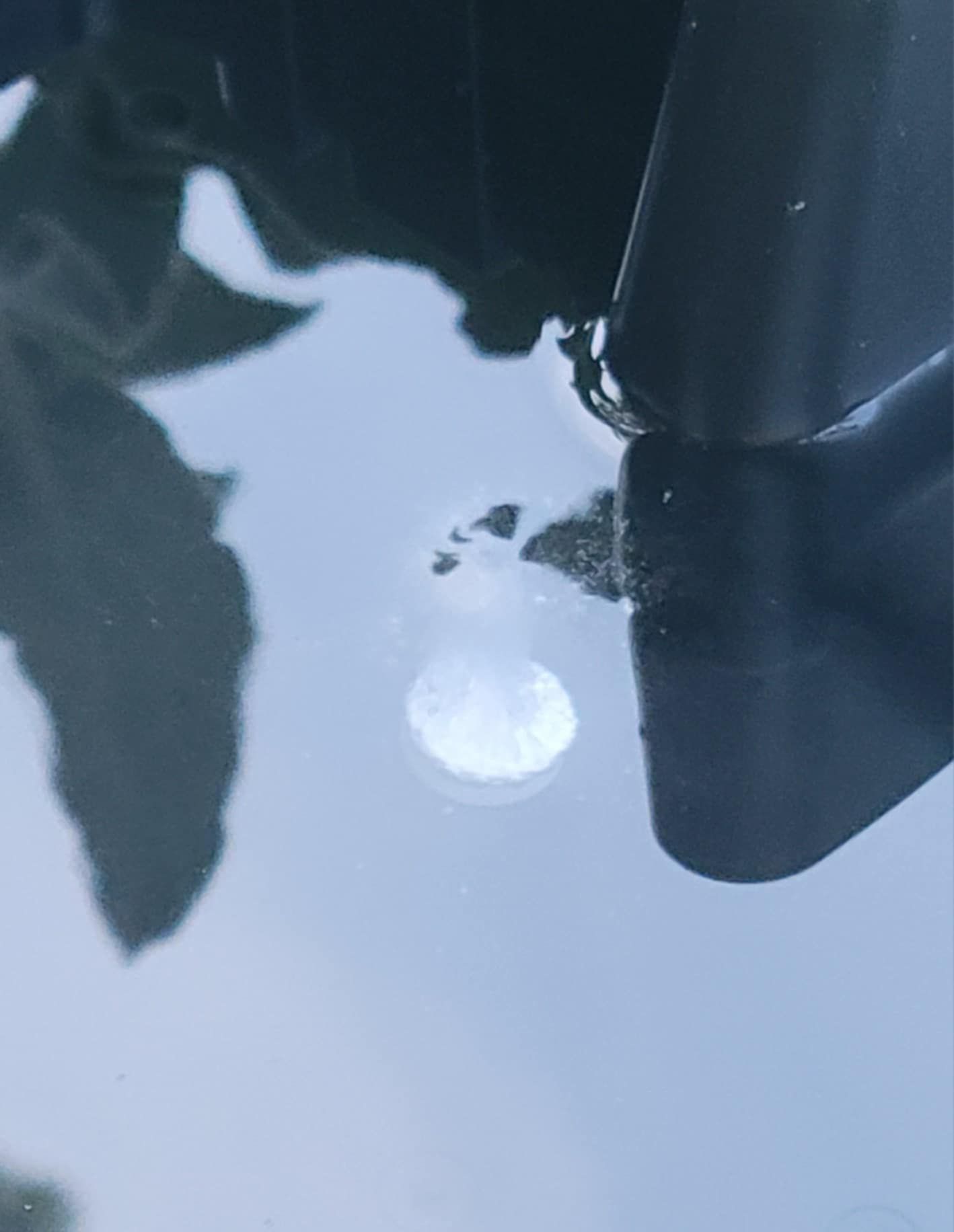 A close up of a boat propeller in the water