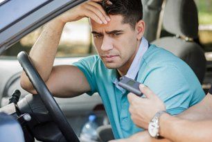 Drunk man caught in car by police officer