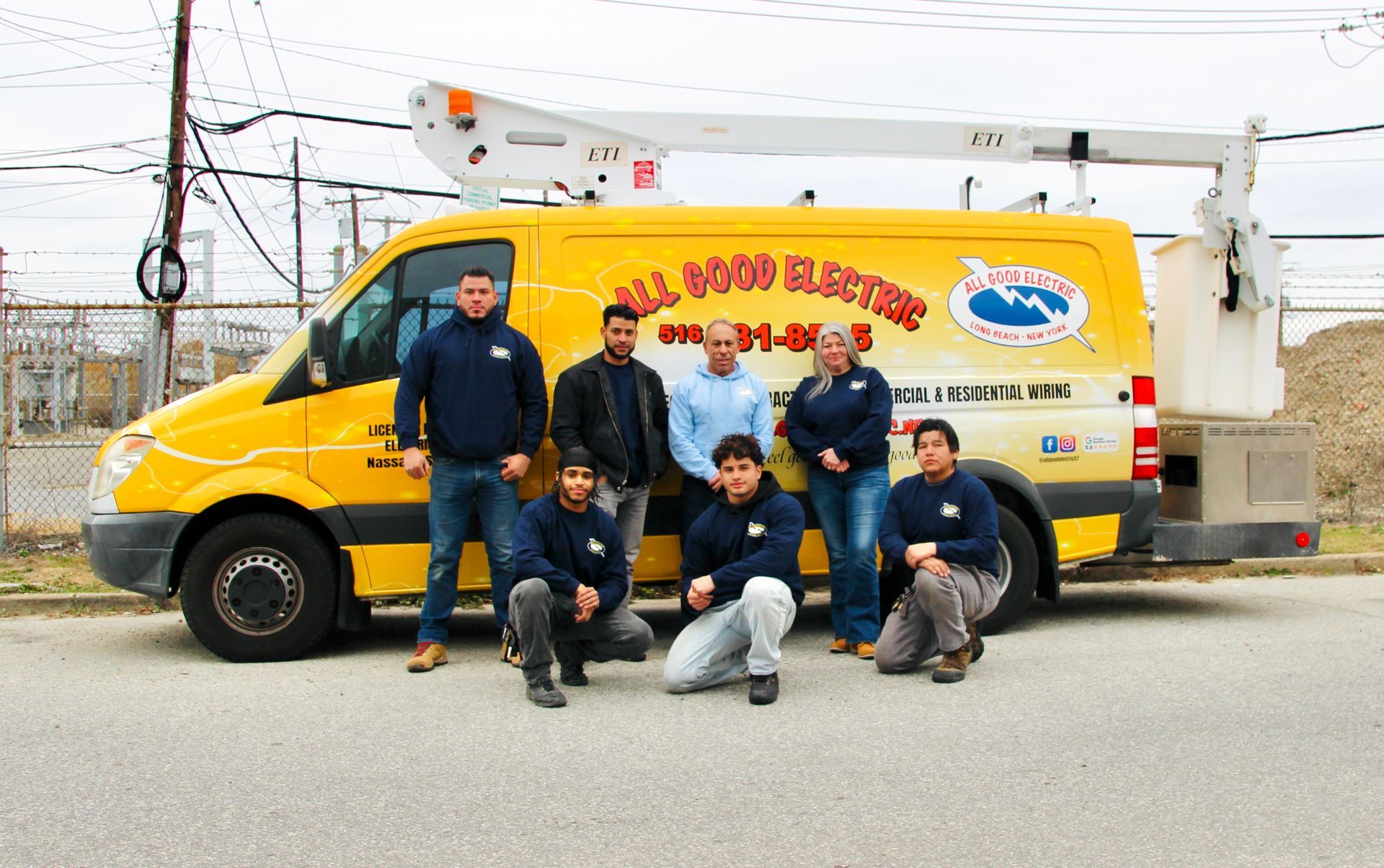 Group of people in front of a yellow 