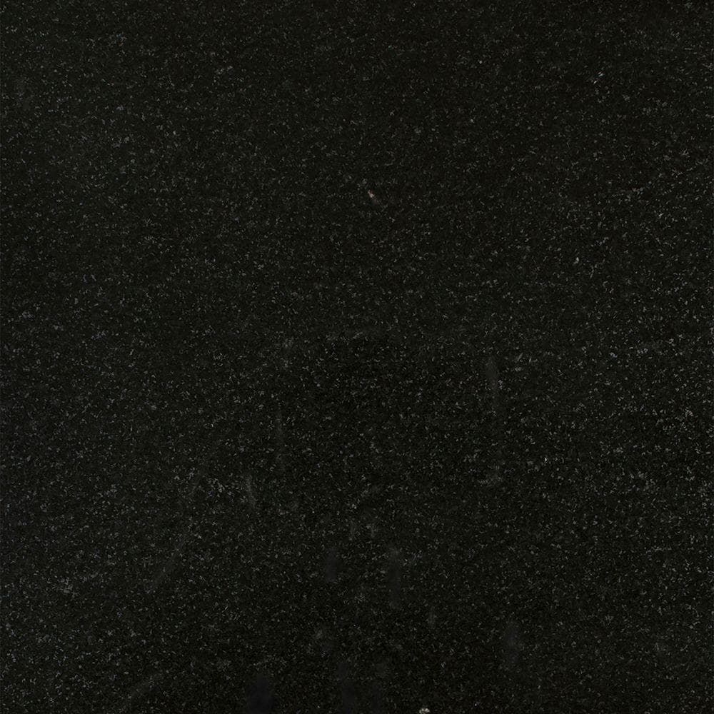 Dark, textured black surface with a subtle speckled pattern.