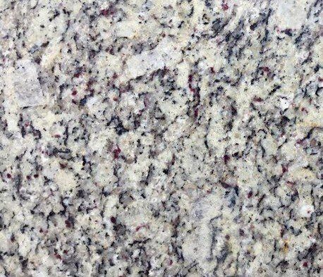 Cream-colored granite countertop with flecks of black, gray, and maroon.