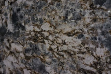 Blue, white, and brown granite countertop with swirling patterns and flecks.