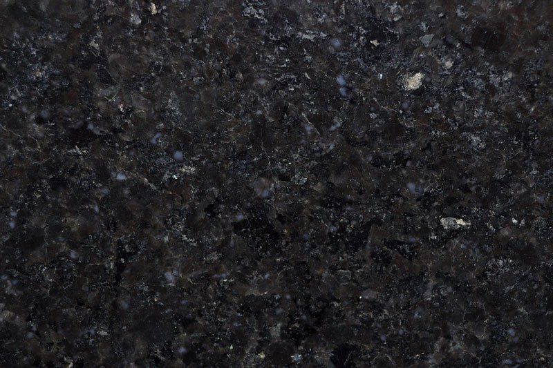 Dark granite with speckled blue and white mineral flecks.