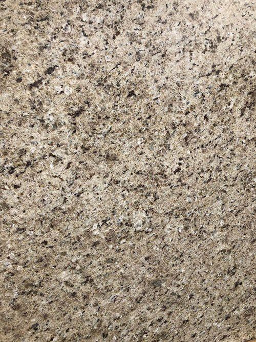 Tan granite countertop with speckled black and brown patterns.