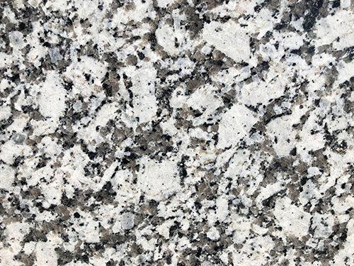 Granite countertop with white, gray, and black speckled pattern.