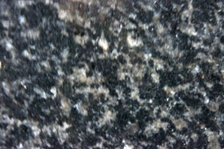 Dark granite countertop with speckled black, gray, and white patterns.