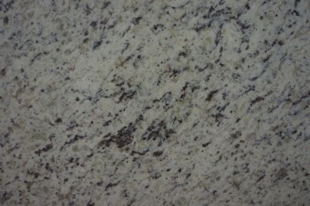 Close-up of granite countertop with speckled white, gray, and black patterns.