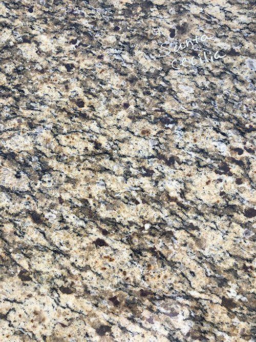 Tan and black granite countertop with a swirling pattern.