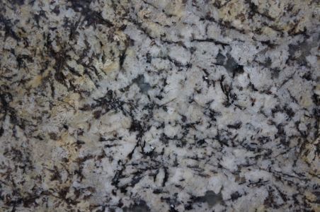 Granite countertop with a mix of white, beige, and black patterns.