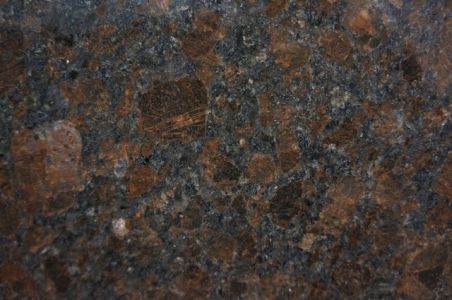 Dark brown and gray speckled granite countertop.