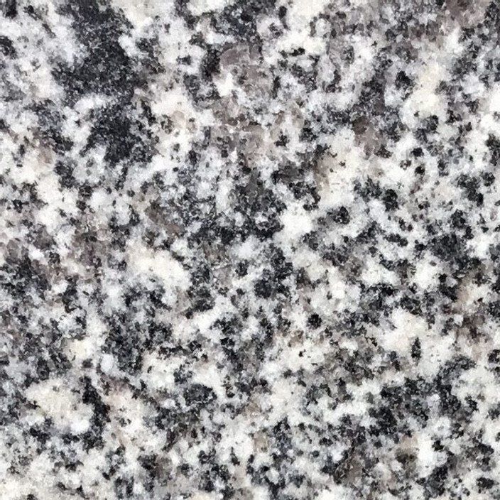 White granite countertop with black and gray speckles.