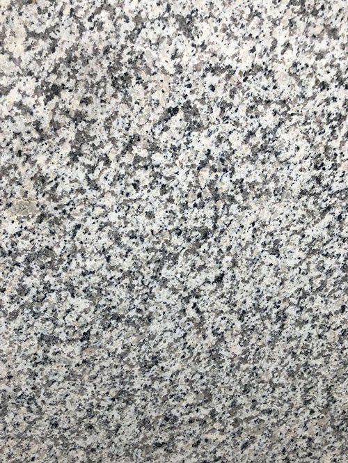 Close-up of speckled gray and white granite stone surface.