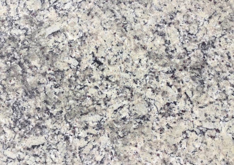 White and gray granite countertop with speckled texture.