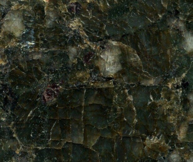 Dark green, textured stone with lighter, crystalline patches and veining.