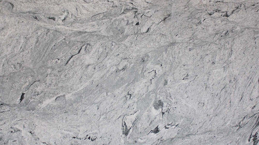 Gray and white granite stone texture with rough, uneven surface.