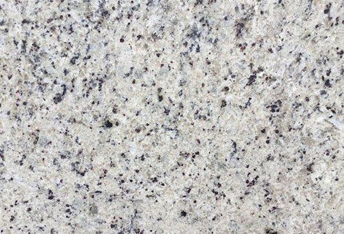 Close-up of light gray granite with black speckles.