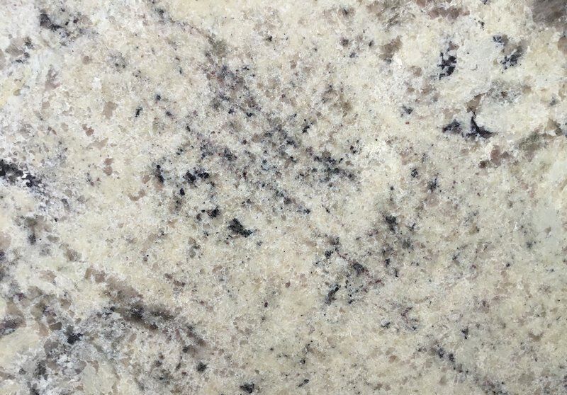 Close-up of beige granite countertop with black and gray speckles.