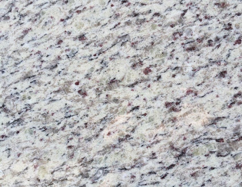 White granite countertop with dark speckles and reddish-brown accents.