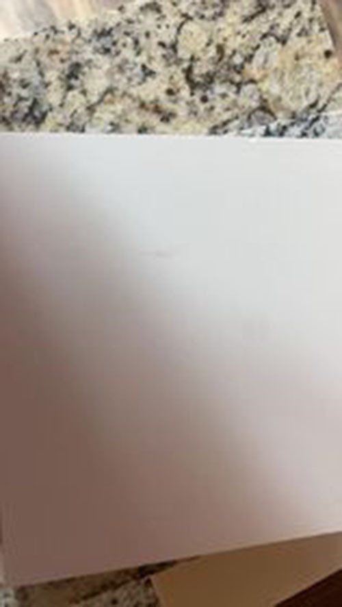 White paper on a speckled granite surface.