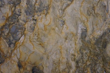 Marble slab with swirls of gold, gray, and white.