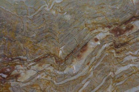 Close-up of marble with swirling patterns in shades of brown, gold, and gray.