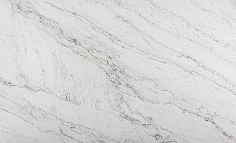 White countertop with gray veining, resembling marble.