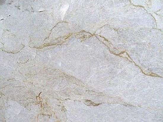 White stone surface with tan veining.