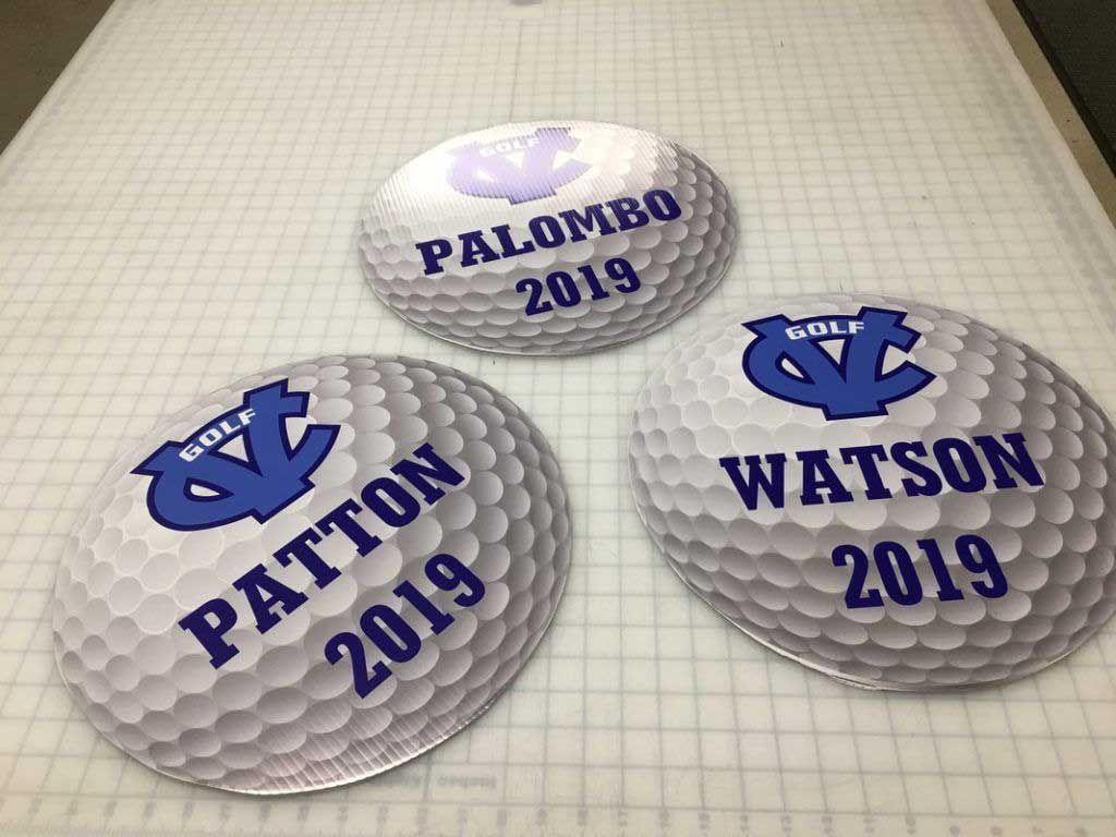 Three custom golf ball signs with names and the UNC logo, 2019.