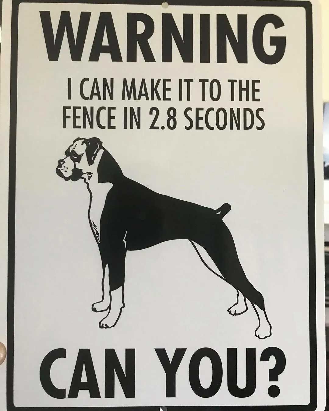White sign with a boxer dog silhouette; text: 