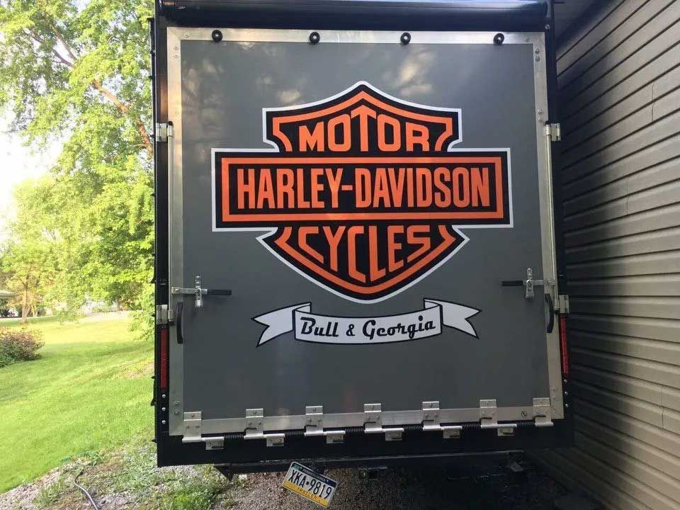 Harley-Davidson logo on a gray trailer door, with 
