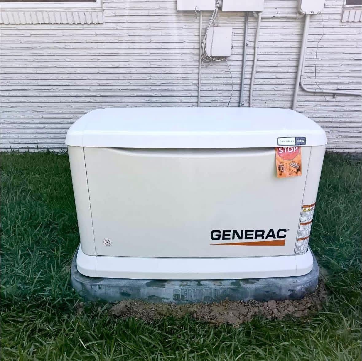 A Generac backup generator sits on a concrete pad against a white siding wall surrounded by grass.