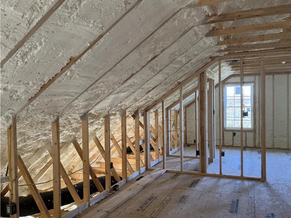 A room in a house under construction with foam on the ceiling.