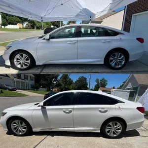 Silver sedan parked under a white net canopy in a residential driveway, side view from two angles