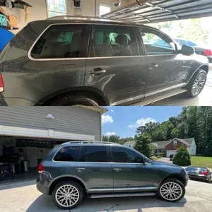 Dark green SUV in a driveway, shown from the side in a garage and outdoors.