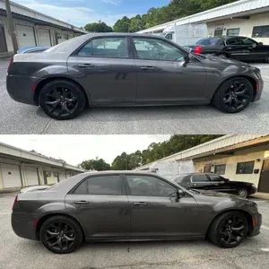 Gray coupe sedan parked in an alley, shown in side view with black wheels.