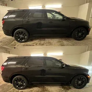 Black SUV in a garage, shown from the side in two stacked photos.