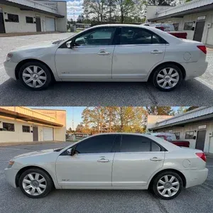 White sedan shown in two side-view photos, one with tinted windows, parked outdoors by buildings.
