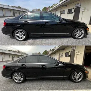 Black sedan shown in side profile, duplicated top and bottom, parked beside a building.