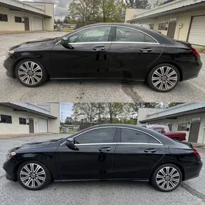 Black sedan shown in side profile in a residential driveway, with tinted windows and alloy wheels.