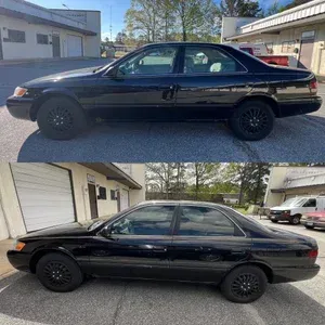 Black sedan shown from side in two outdoor parking-lot views.