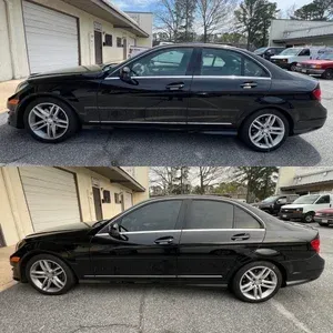 Black sedan shown from side in two views, parked beside a building and garage.