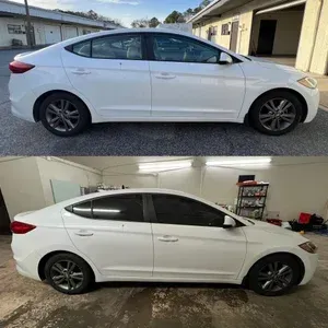 White sedan shown outdoors and indoors in side profile, with dark tinted windows and black wheels.
