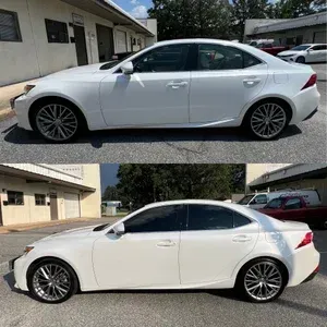 White sedan shown in side view, with a tinted windows and multi-spoke wheels, parked in a lot.