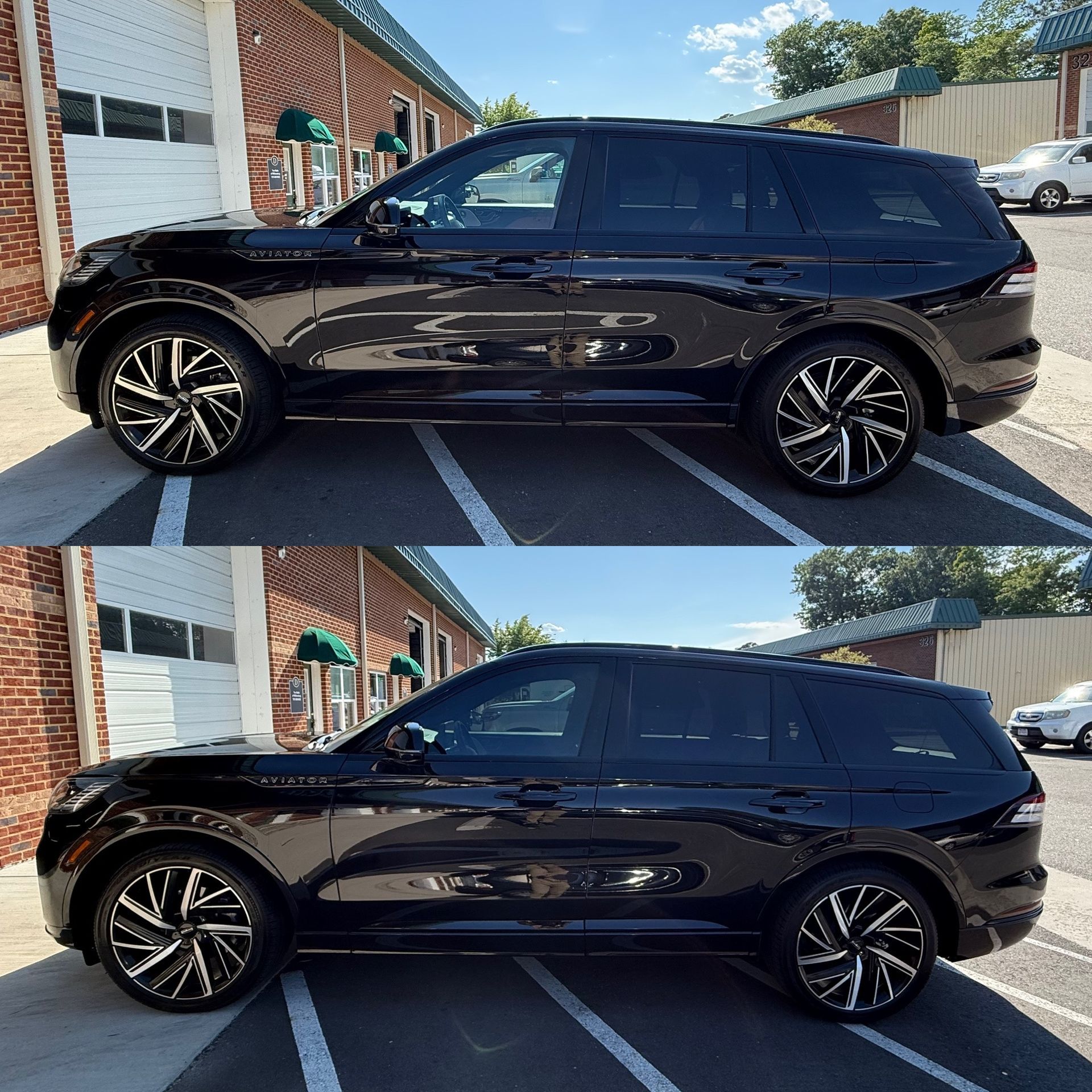 Black SUV parked outside a brick building, shown in side view with tinted windows and alloy wheels