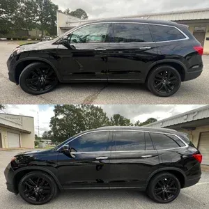Black SUV shown from the side in two nearly identical outdoor parking lot photos.