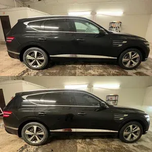 Black SUV shown in side profile in a garage, with a low roofline and silver wheels