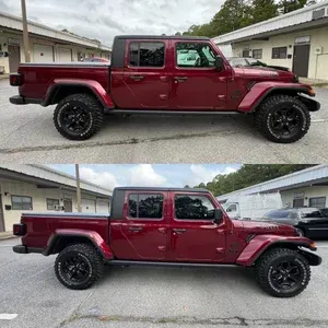 Maroon lifted pickup truck shown in side profile, parked between buildings