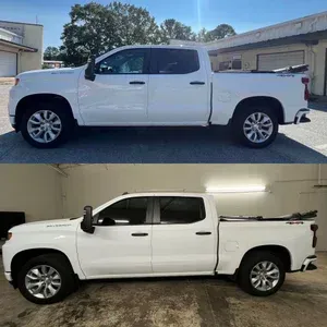 White crew cab pickup truck shown outdoors and indoors in side profile.