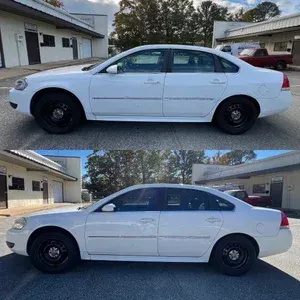 White sedan shown in side profile outside a building, with black wheels and daytime lighting